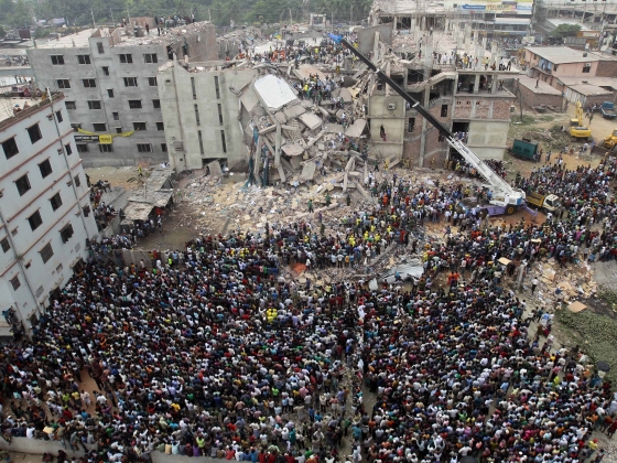 A sea of garment workers striking in Bangladesh, their fists raised against a backdrop of smog-choked skies.