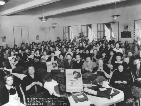 A photo taken in 1941 of a large group of women at a knitting circle luncheon event for the International Workers Order.