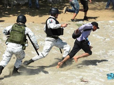 Mexican marines chasing a migrant on-foot