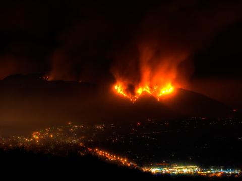 Picture of 2025 LA Fires burning the hills above the city.