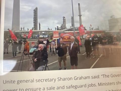 Photograph of protest outside the refinery. UNITE union banners can be seen.