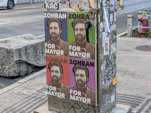 Election posters of Zohran Mamdani wheatpasted on a utility box in New York City