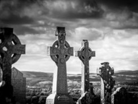 Graveyard depicting several Celtic Cross design tombstones.