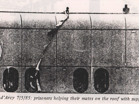 Bois d'arcy prison - two prisoners are protesting on the roof - being passed supplies by their friends from a window