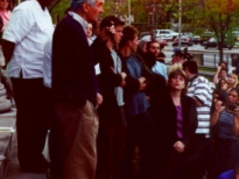 Howard Zinn speaks, with Matt Damon and Ben Affleck in background