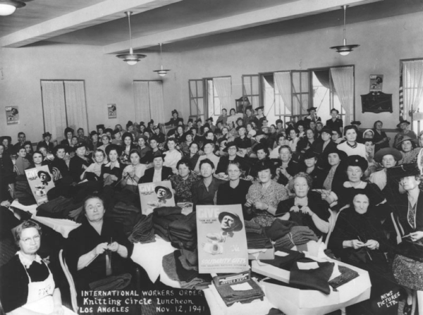 A photo taken in 1941 of a large group of women at a knitting circle luncheon event for the International Workers Order.