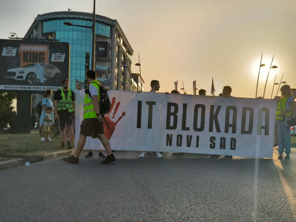 IT Blokada road blockade in Novi Sad, Serbia with a contingent of activists in neon green safety vests.