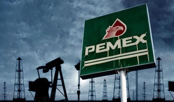 Pemex sign with oil field in the background