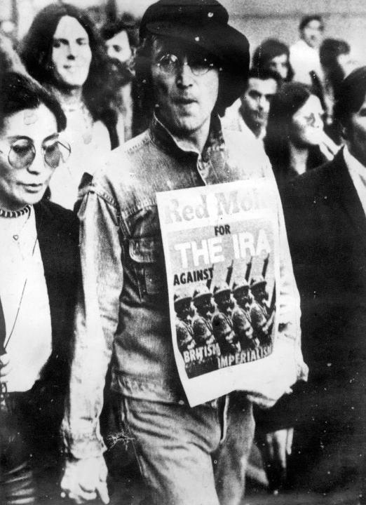 John Lennon holding an issue of "Red Mole"