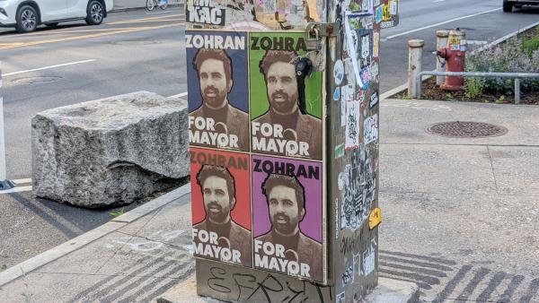 Election posters of Zohran Mamdani wheatpasted on a utility box in New York City