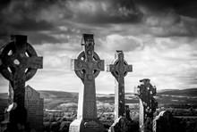 Graveyard depicting several Celtic Cross design tombstones.