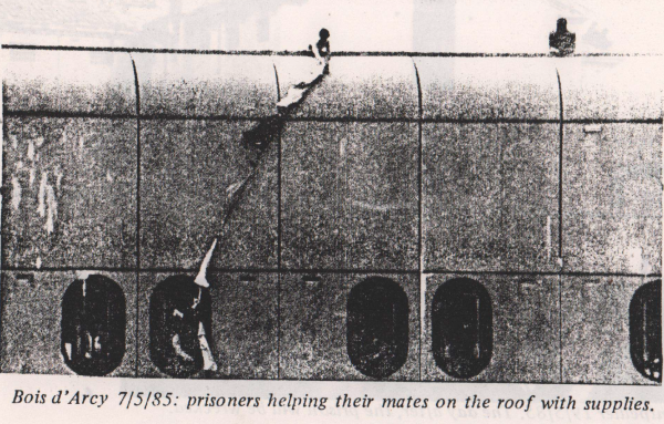 Bois d'arcy prison - two prisoners are protesting on the roof - being passed supplies by their friends from a window