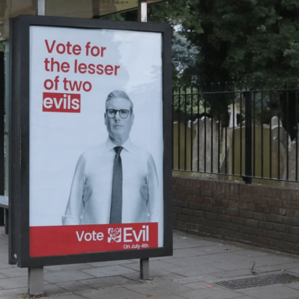 A vandalized or "détourned" election day poster for former U.K. Labor Party leader Keir Starmer who is featured on the right-side of it while the text to the left of him has been changed to say "Vote for the lesser of two evils" and the text on the horizontal red bar below him saying "Vote Evil" with "On July 4th" in smaller text below it.