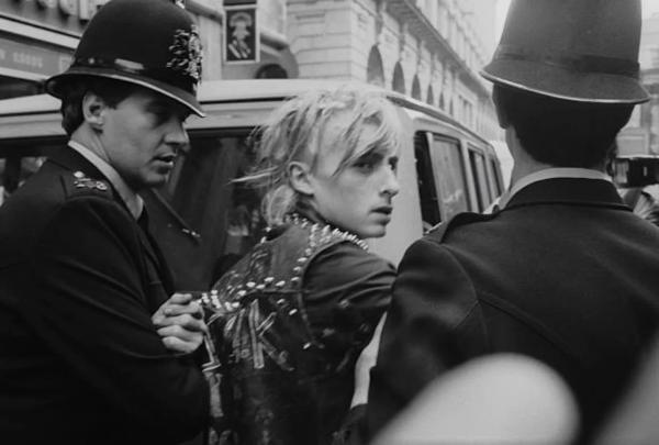 a punk and two cops in the City of London, 1980s.