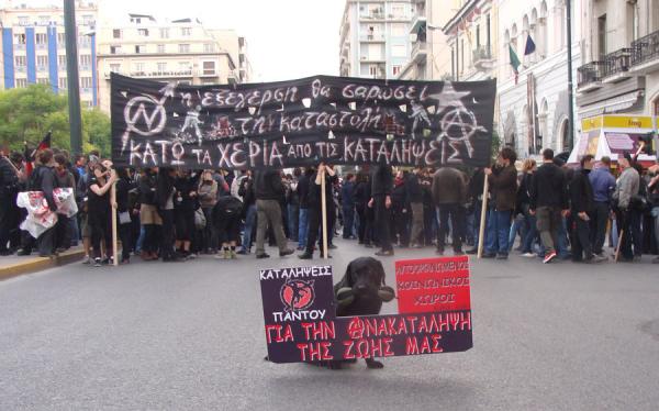 front banner of Athens protest march: "insurrection will smash repression - hands off the squats"