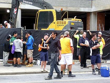 Workers walk off a constructions site in the Perth CDB